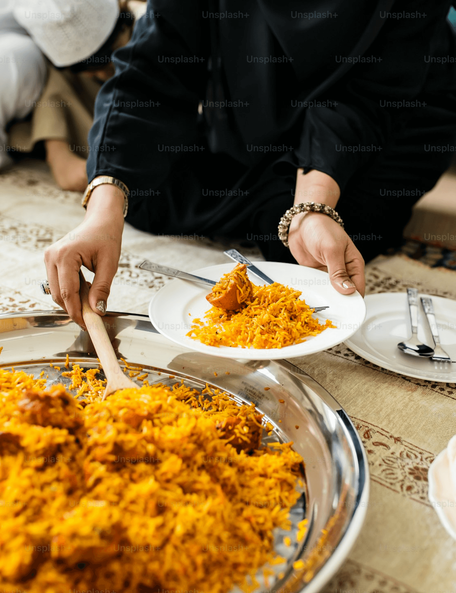 Serving biryani from a platter