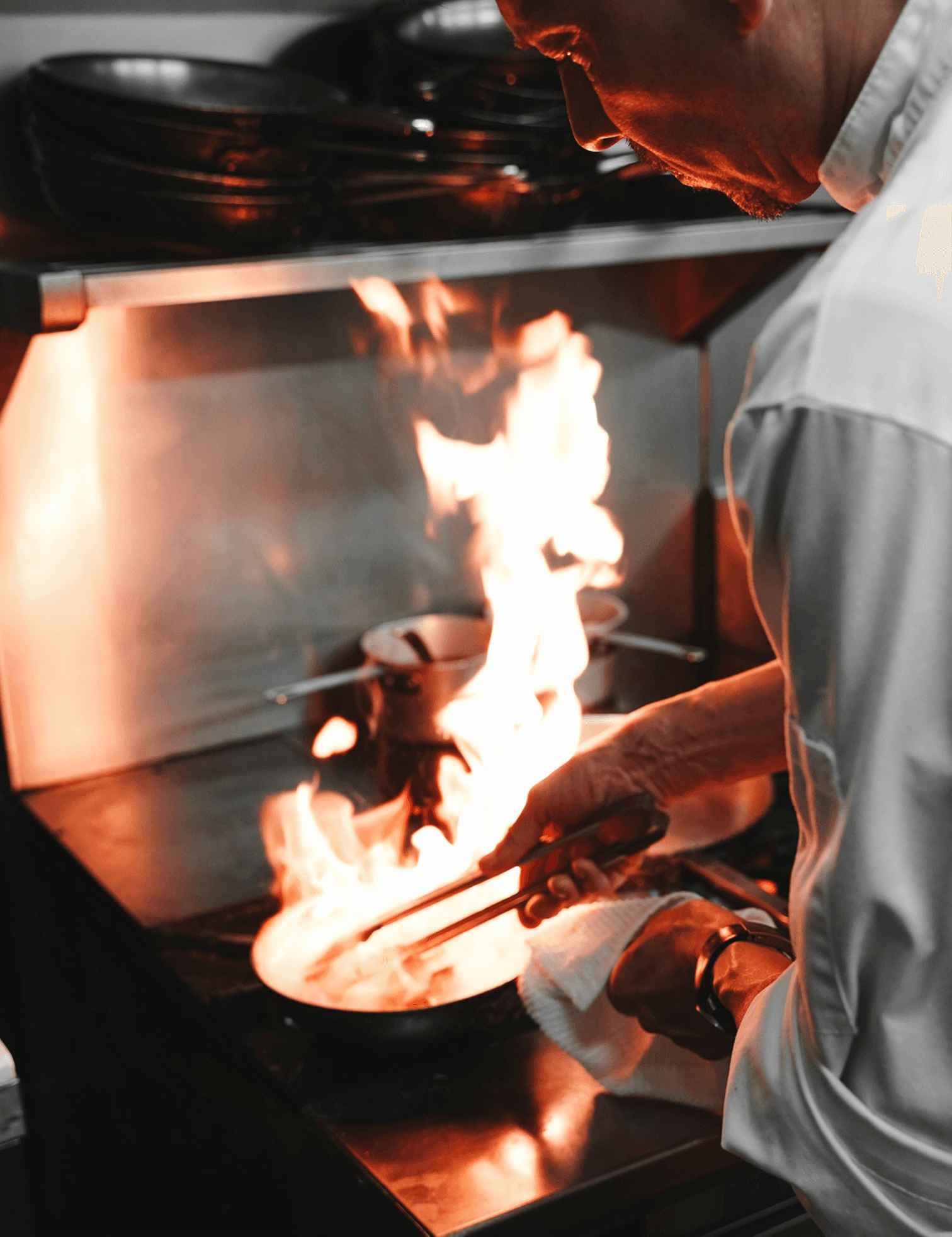 Chef flambéing food in the kitchen
